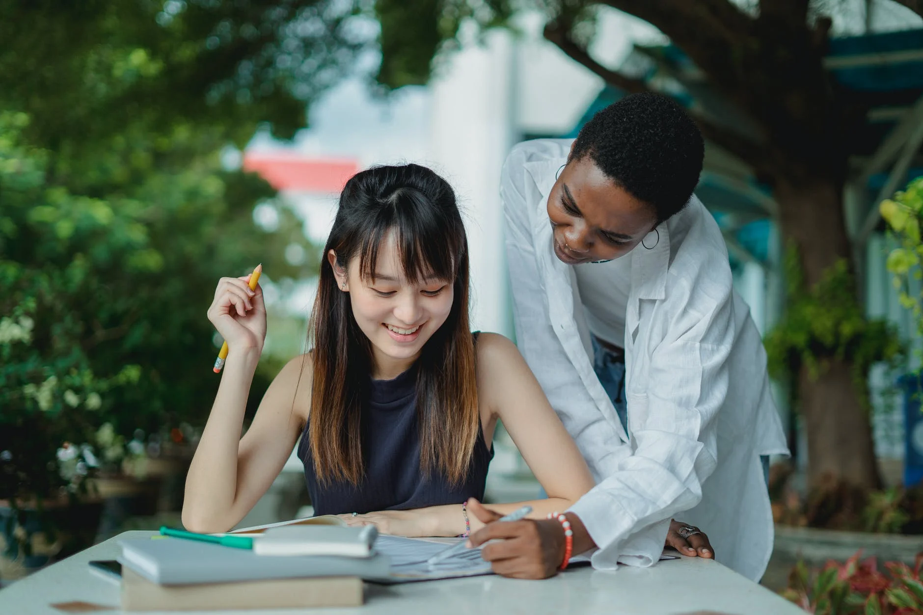 multiethnic female friends studying with books